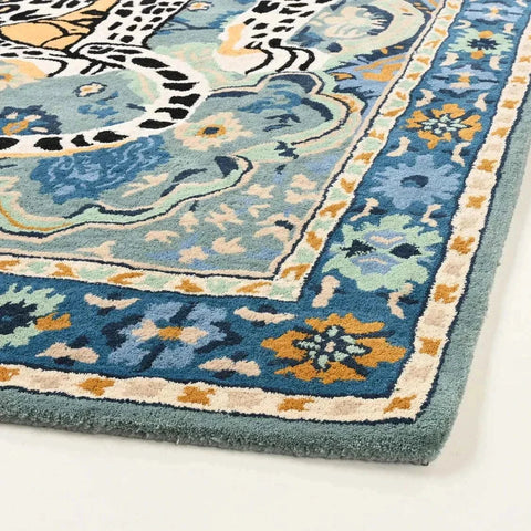 Hand-tufted leopard area rug with vintage Persian design in soft blues, beige, and black wool